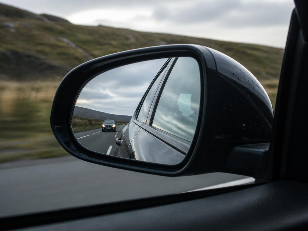 Side mirror reflecting the road